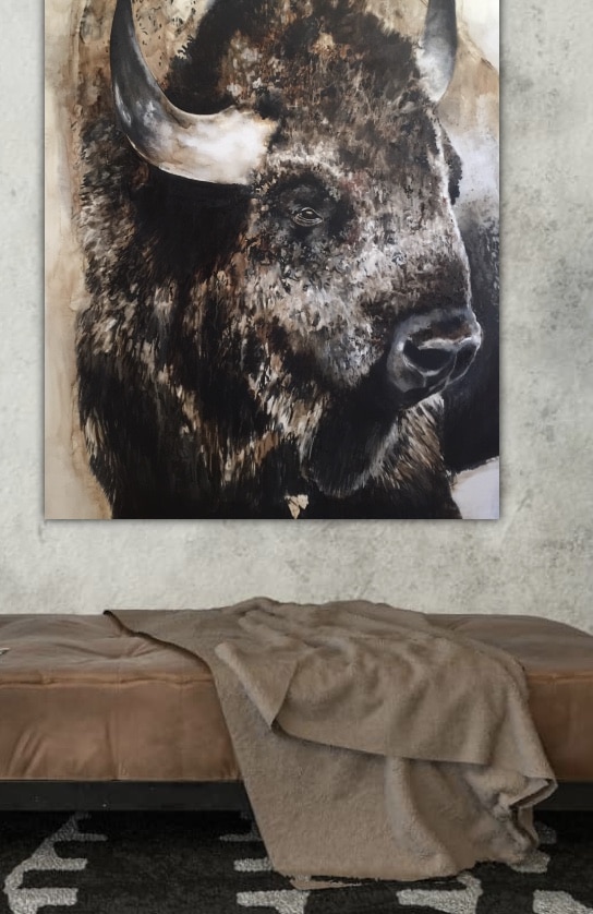 A bison painting displayed prominently in the center of a living room