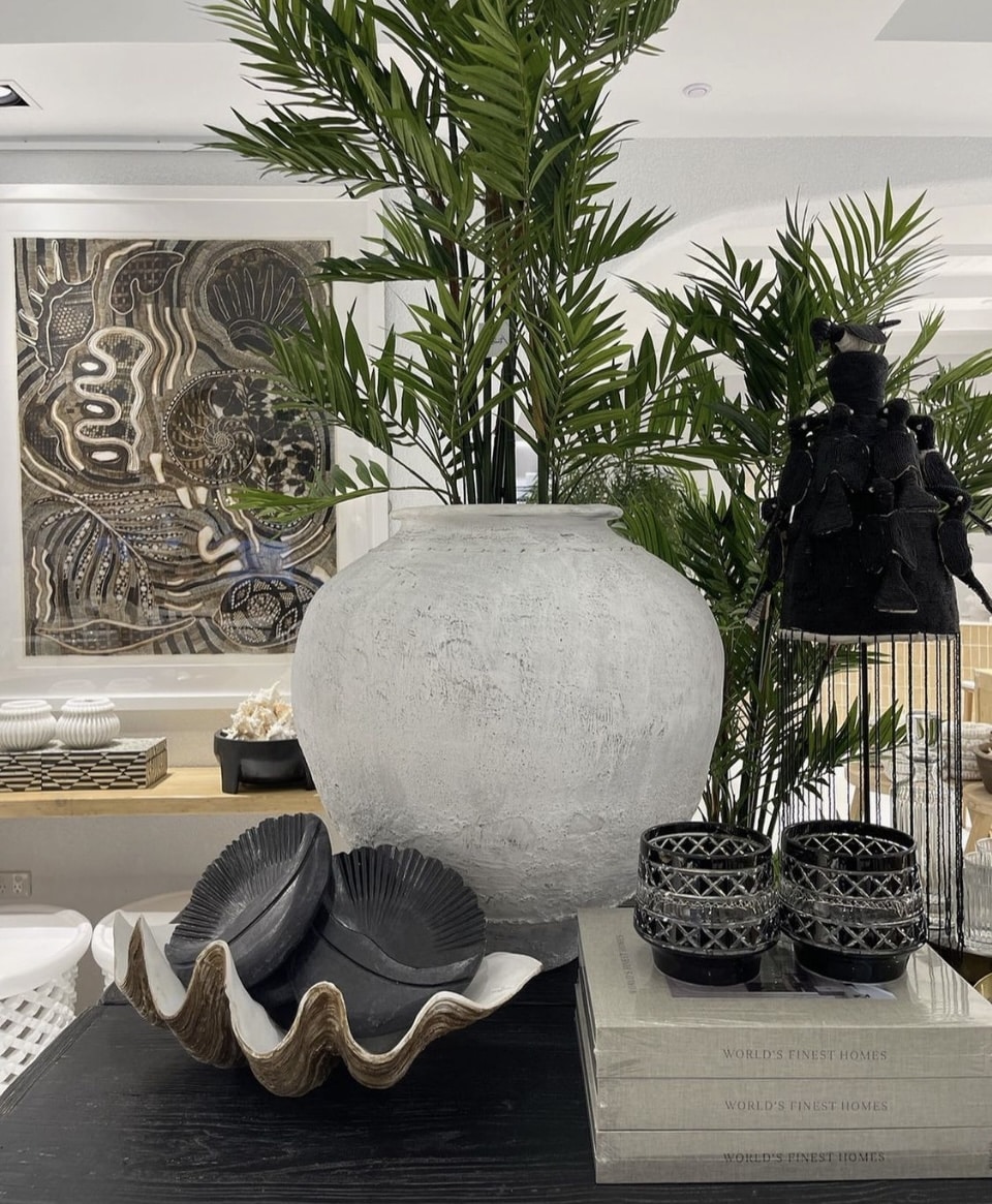 A painting and a vase displayed side by side in the center of a living room