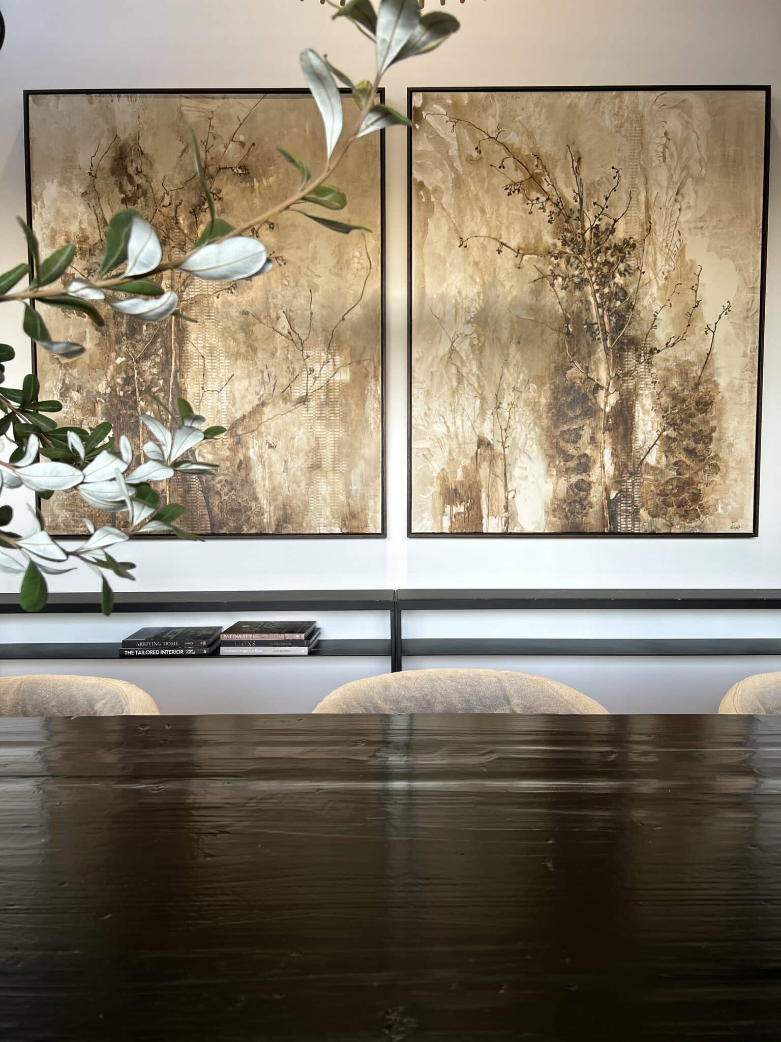 Two framed paintings hanging symmetrically in the center of a living room